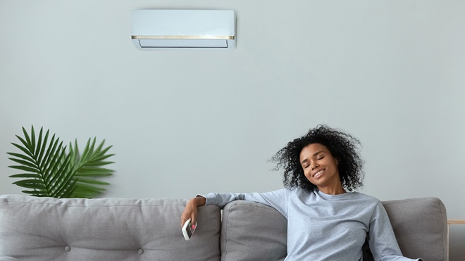 person on lounge in living room with air conditioner